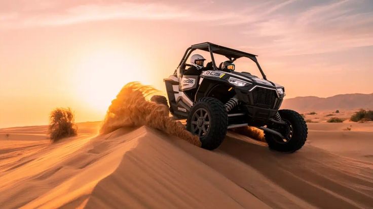 Dune buggy carving through red sand dune